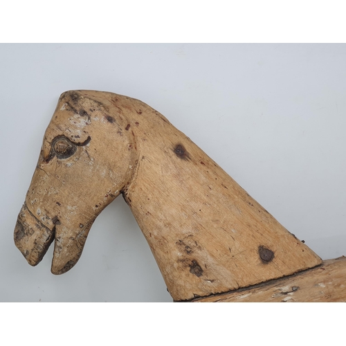 476 - A folk art carved wooden Model of a Horse (lacking legs) 20in x 12in, a leather covered toy Horse A/... 