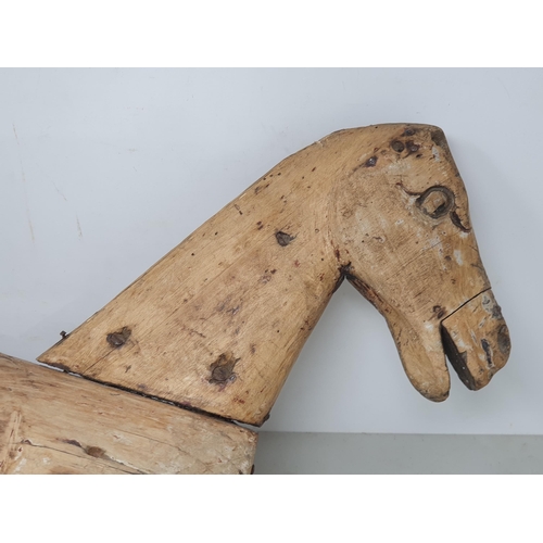 476 - A folk art carved wooden Model of a Horse (lacking legs) 20in x 12in, a leather covered toy Horse A/... 