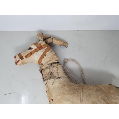 476 - A folk art carved wooden Model of a Horse (lacking legs) 20in x 12in, a leather covered toy Horse A/... 