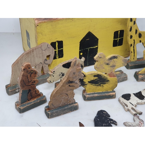 479 - A painted wooden folk art Toy House with jigsaw cut wooden farm and zoo Animals and two carved and p... 