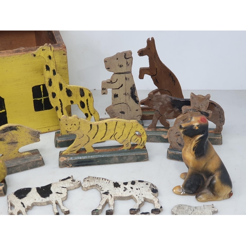 479 - A painted wooden folk art Toy House with jigsaw cut wooden farm and zoo Animals and two carved and p... 