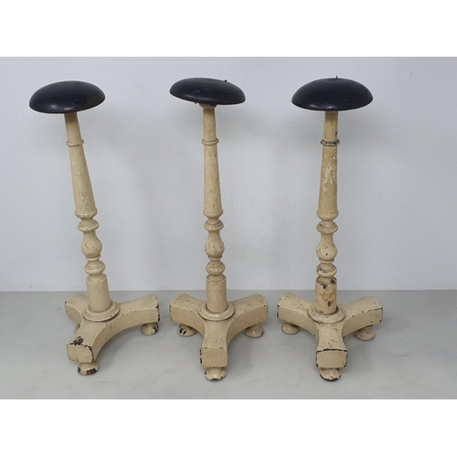 490 - Three cream painted Wig Stands (one A/F) 13in H, three child's straw Boaters and another straw Hat