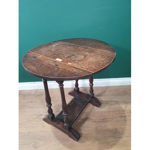 497 - An antique oak dropleaf Occasional Table with swivel top on baluster turned supports 2ft 1in W x 2ft... 