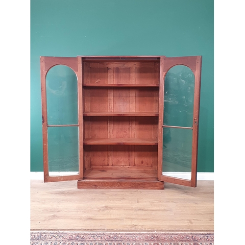 502 - A Victorian mahogany veneered Bookcase fitted pair of arched glazed doors enclosing adjustable shelv... 