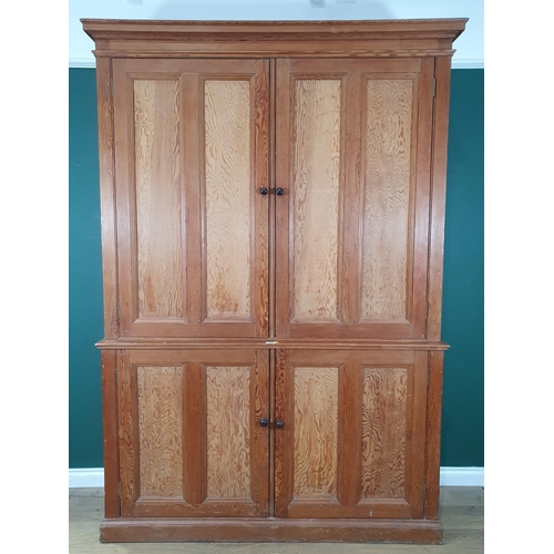 504 - A large pitch pine two piece Cupboard, with four panelled doors enclosing fitted shelve interior, 7f... 