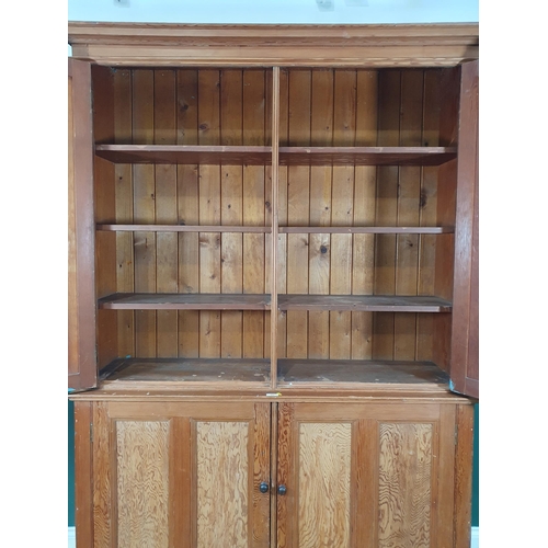 504 - A large pitch pine two piece Cupboard, with four panelled doors enclosing fitted shelve interior, 7f... 