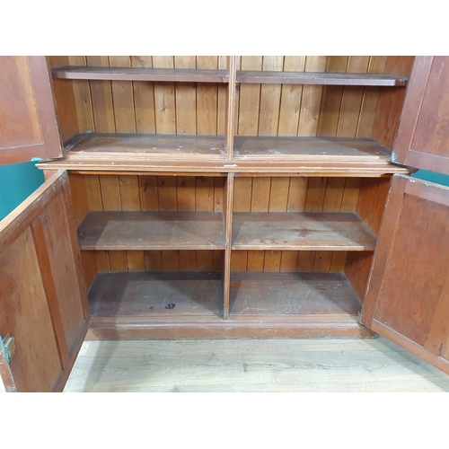 504 - A large pitch pine two piece Cupboard, with four panelled doors enclosing fitted shelve interior, 7f... 