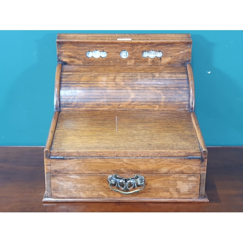 569 - An antique oak Writing Slope/Desk with date reel, tambour front revealing letter rack and with hinge... 