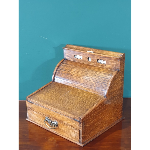 569 - An antique oak Writing Slope/Desk with date reel, tambour front revealing letter rack and with hinge... 