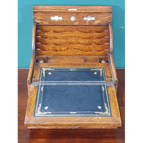 569 - An antique oak Writing Slope/Desk with date reel, tambour front revealing letter rack and with hinge... 