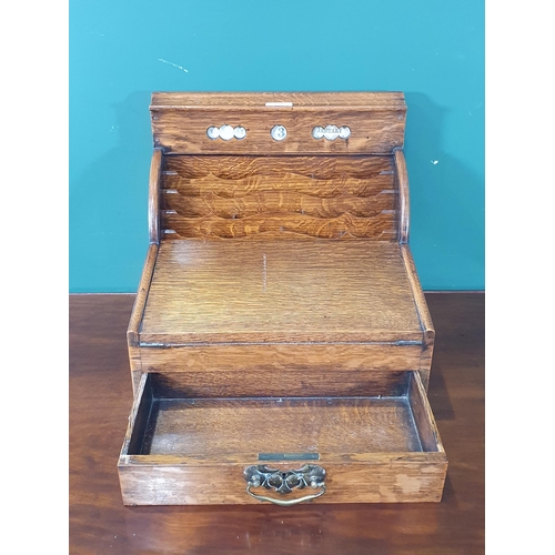 569 - An antique oak Writing Slope/Desk with date reel, tambour front revealing letter rack and with hinge... 