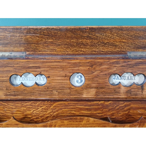 569 - An antique oak Writing Slope/Desk with date reel, tambour front revealing letter rack and with hinge... 