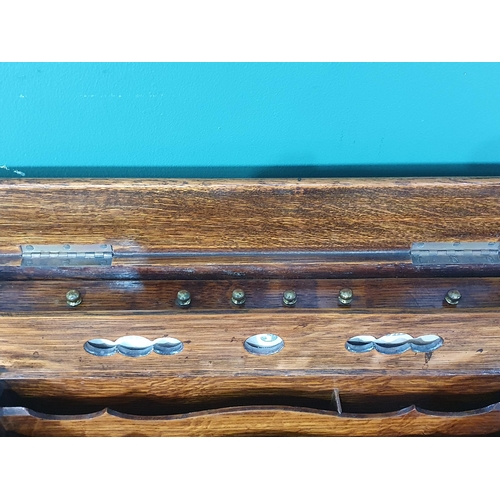 569 - An antique oak Writing Slope/Desk with date reel, tambour front revealing letter rack and with hinge... 