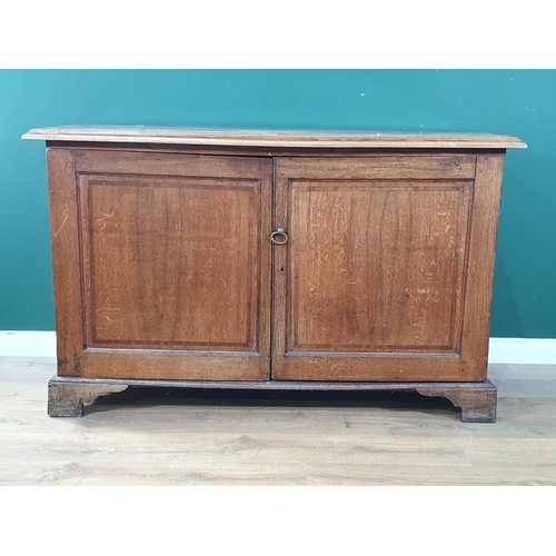 593 - An antique oak Cupboard fitted pair of fielded panel doors enclosing six drawers raised on ogee brac... 