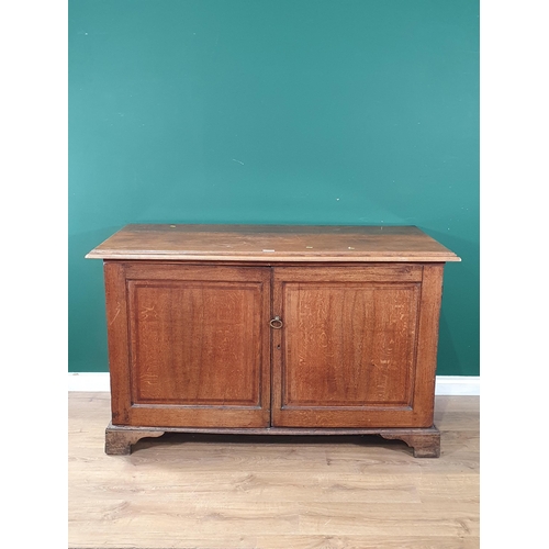 593 - An antique oak Cupboard fitted pair of fielded panel doors enclosing six drawers raised on ogee brac... 