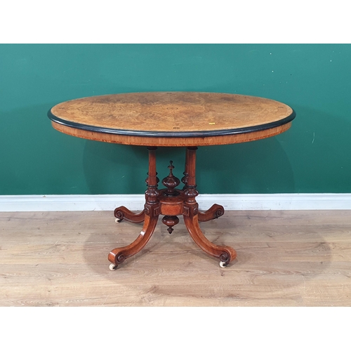 594 - A Victorian burr walnut veneered and inlaid Loo Table with oval  tilt top raised on four turned and ... 