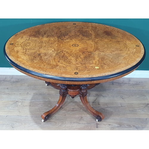 594 - A Victorian burr walnut veneered and inlaid Loo Table with oval  tilt top raised on four turned and ... 