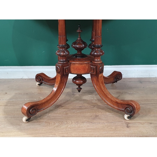 594 - A Victorian burr walnut veneered and inlaid Loo Table with oval  tilt top raised on four turned and ... 