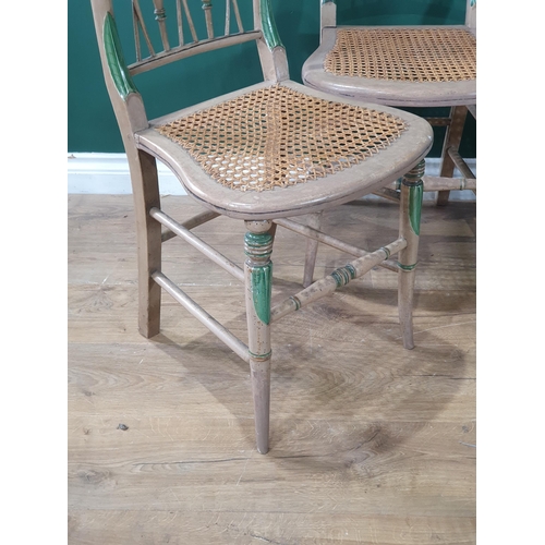 615 - A set of four 19th Century green painted Chairs with turned spindle, wicker crossed braces and cane ... 