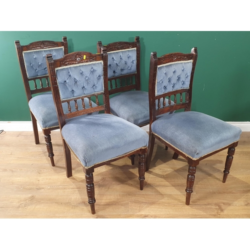 623 - A set of four Victorian Dining Chairs with floral carved top rails and blue upholstered button backs... 