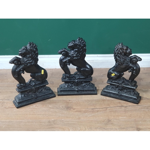 630 - Three black painted cast iron Doorstops in the form of rearing lions 14in H (R7)