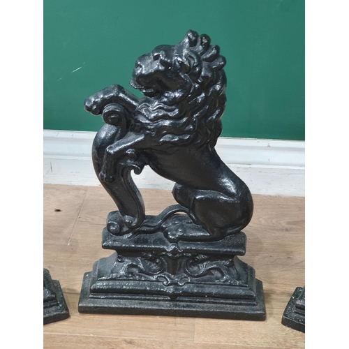 630 - Three black painted cast iron Doorstops in the form of rearing lions 14in H (R7)