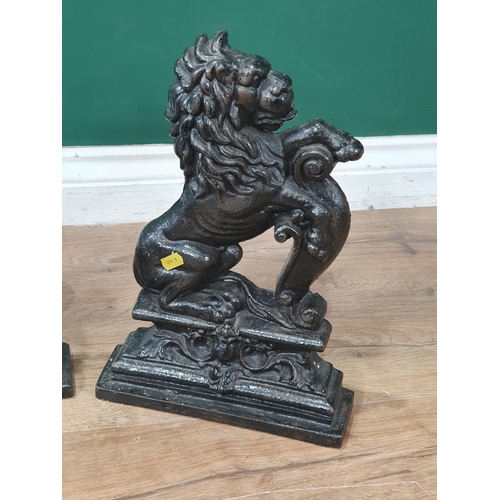 630 - Three black painted cast iron Doorstops in the form of rearing lions 14in H (R7)