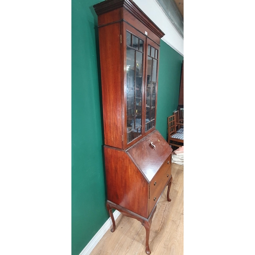 635 - A mahogany veneered Bureau Bookcase with glazed upper section above base fitted two drawers raised o... 