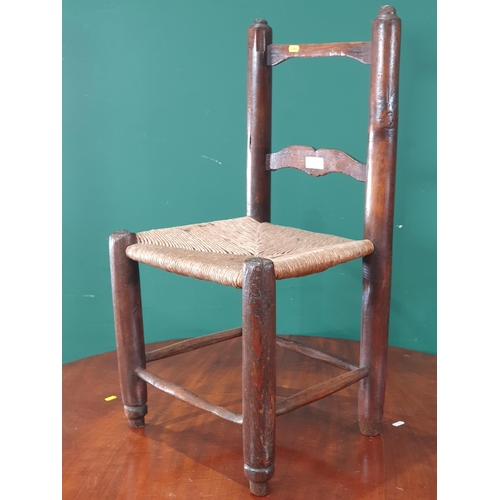 67 - An primitive pine child's Chair with rush seat 2ft 7in H (R9)