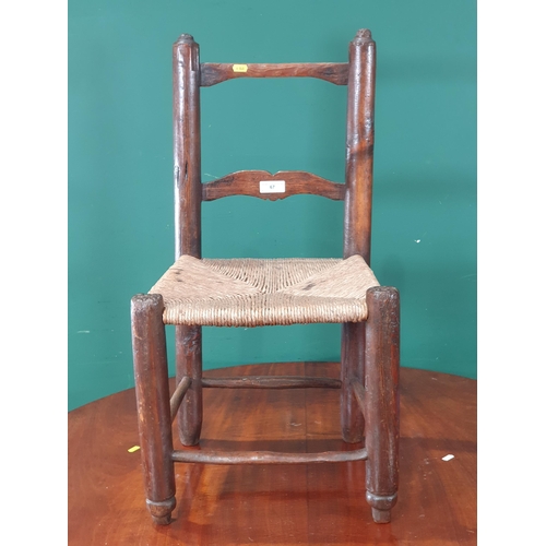 67 - An primitive pine child's Chair with rush seat 2ft 7in H (R9)