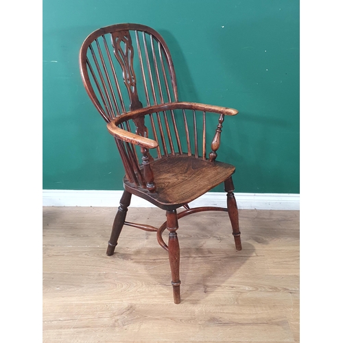 701 - A 19th Century ash and yew Windsor Elbow Chair with pierced splat back raised on turned supports wit... 