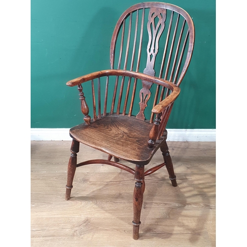 701 - A 19th Century ash and yew Windsor Elbow Chair with pierced splat back raised on turned supports wit... 