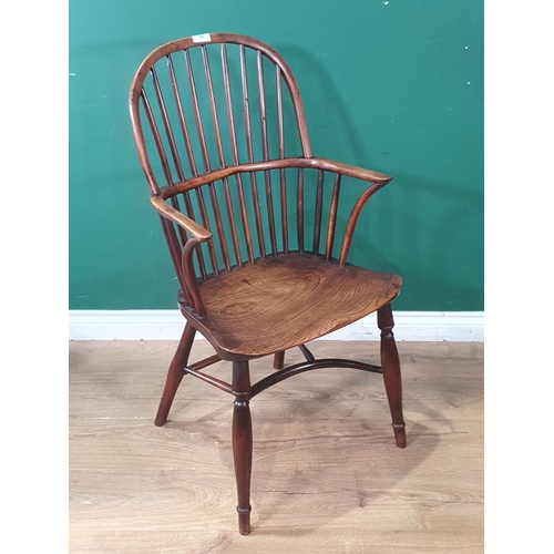 703 - A 19th Century ash and yew stick back Windsor Elbow Chair on slim turned supports united by crinolin... 