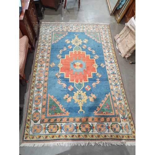 748 - A Persian Rug, the border with geometric designs and central medallion on a blue ground,  9ft 5in x ... 