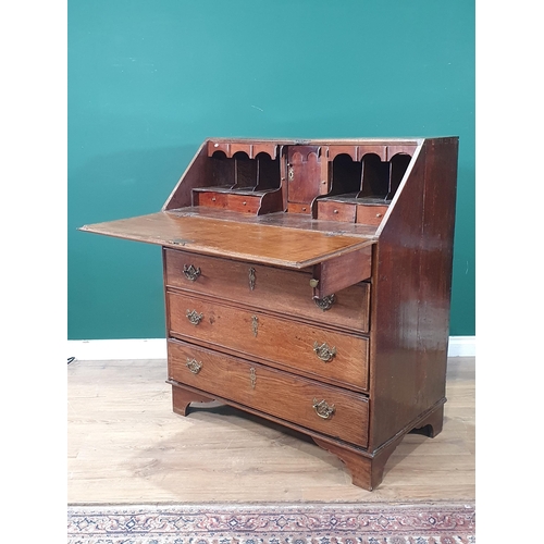 86 - A Georgian oak Bureau with fall front above two short and three long drawers mounted on bracket feet... 