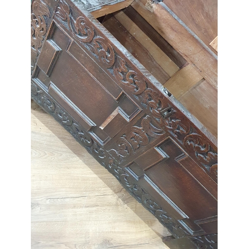 87 - A 17th Century oak Coffer with tulip and leafage carving surrounding two geometric moulded panels A/... 