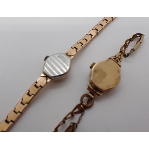 156 - A lady's Baume manual wind Wristwatch in gold plated and stainless steel case on gilt metal bracelet... 