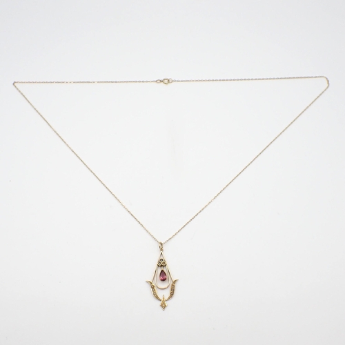 172 - A pink Tourmaline and Seed Pearl Pendant with central drop millegrain-set pear-cut tourmaline suspen... 