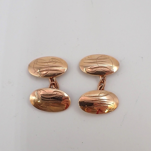 203 - A pair of 9ct gold oval Cufflinks engraved monograms, approx 8gms