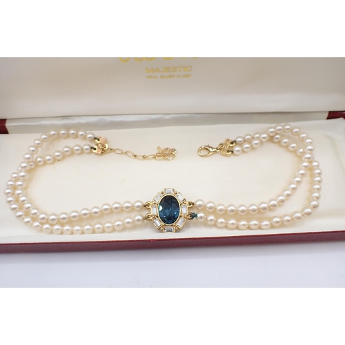 214 - A Rosita simulated pearl two strand Choker with central blue and white stone cluster together with m... 