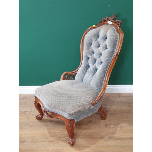 815 - A Victorian walnut Nursing Chair with button upholstery on scrolled front supports A/F .(R7).