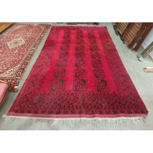 800 - A multi bordered Bokhara Carpet with three rows of seven large guls on a red ground, 7ft 3in x 10ft ... 