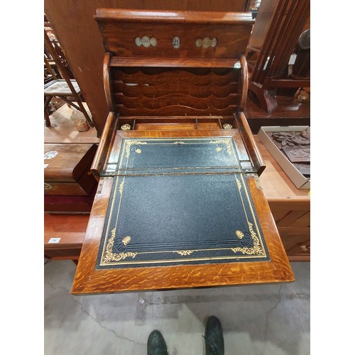 569 - An antique oak Writing Slope/Desk with date reel, tambour front revealing letter rack and with hinge... 