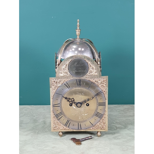 1000 - An antique Lantern Clock with bell surmount, arched brass dial, silvered chapter ring, pierced and e... 