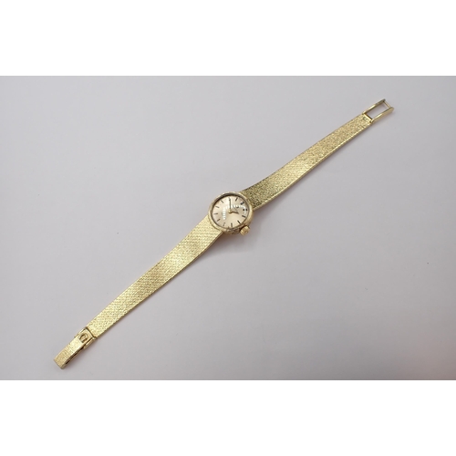 151 - An Omega Geneve lady's Wristwatch the champagne dial with hourly baton markers in 18ct gold case on ... 