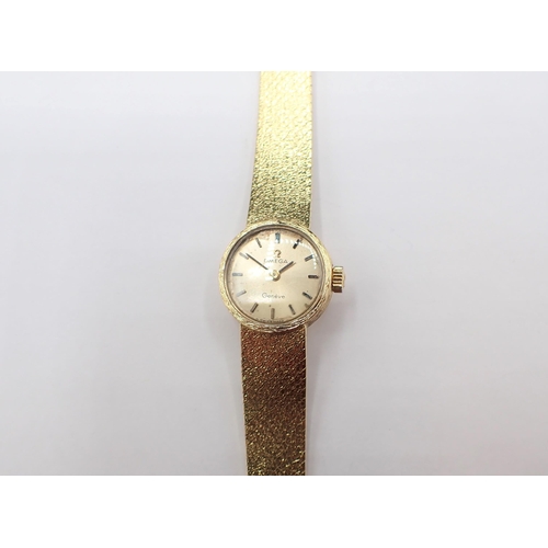 151 - An Omega Geneve lady's Wristwatch the champagne dial with hourly baton markers in 18ct gold case on ... 