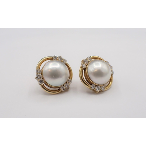 153 - A pair of Mabé Pearl and Diamond Earrings each set central pearl in halo frame peg-set three trios o... 