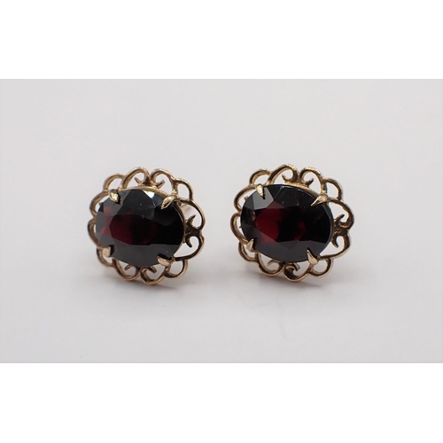 167 - A pair of Garnet Ear Studs each claw-set oval-cut stone in 9ct gold openwork frame, approx 2.80gms