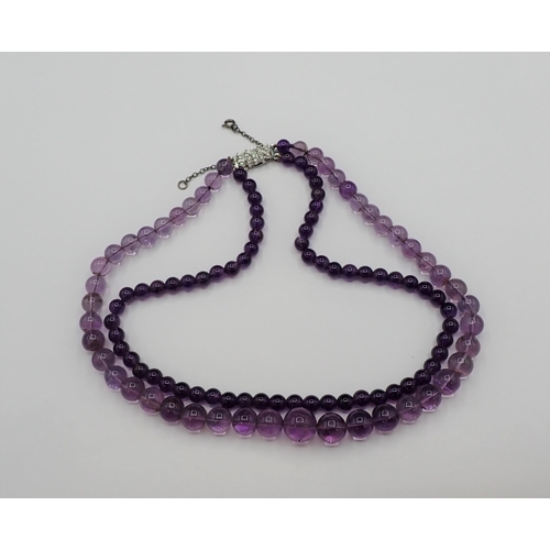 174 - An Amethyst two strand bead Necklace and a pair of Ear Studs