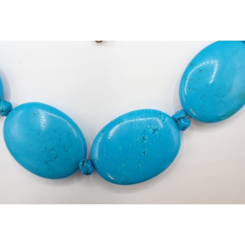 175 - A Turquoise Necklace comprised of ten large ovoid discs